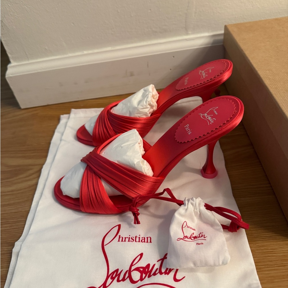 Bright pink satin Louboutin pumps